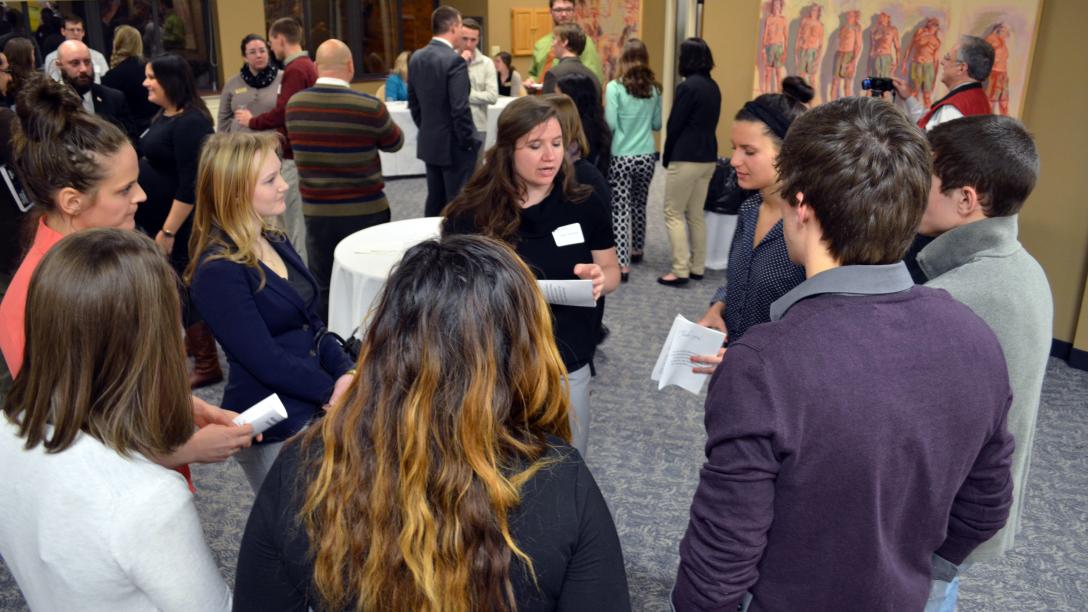 a group of college students gather at a networking event